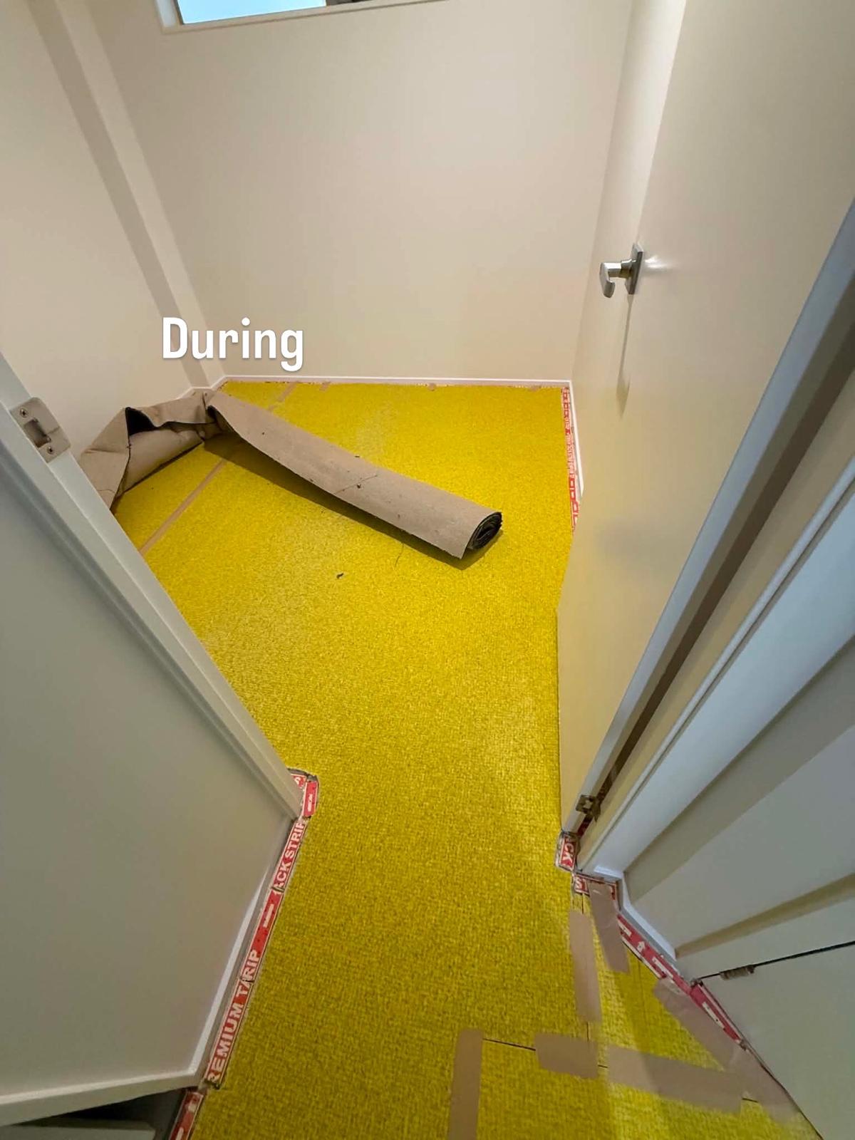 Cupboard mid-installation with new carpet being trimmed to fit the recess