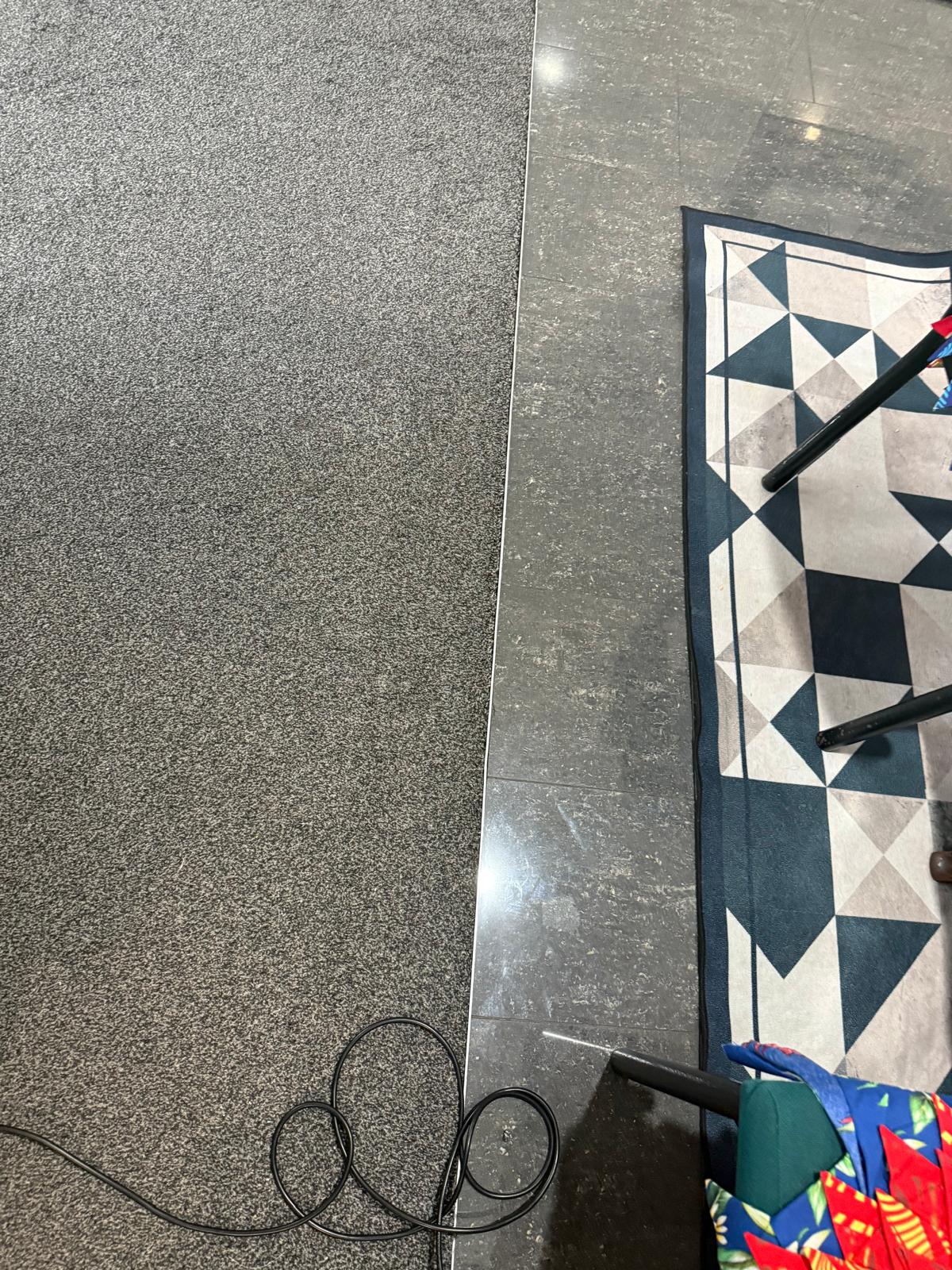 Finished carpet-to-tile join with a clean, secure edge after repair